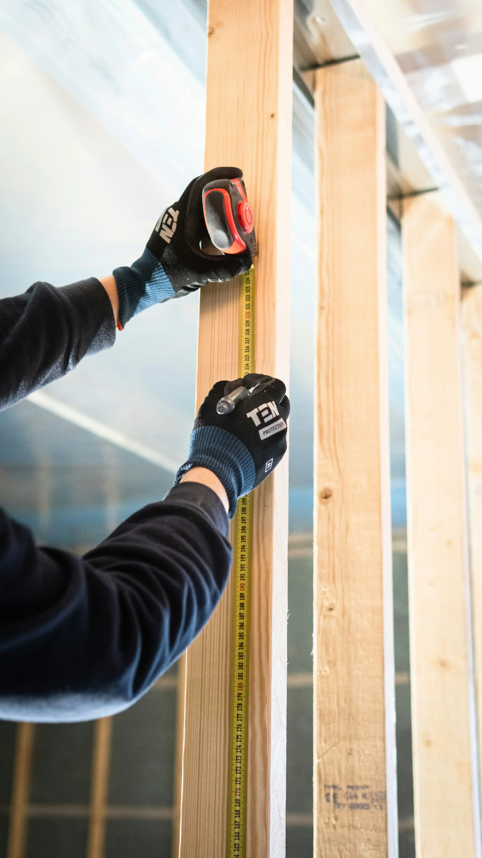 Close-up of pre-drywall wall framing showing vapor barrier and stud connections where air sealing is critical